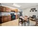 Kitchen with wooden cabinets, dining table, adjacent to a door and wall decor at 8337 Fussell Rd, Polk City, FL 33868