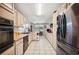 Long galley kitchen with neutral-toned cabinets and modern appliances at 8337 Fussell Rd, Polk City, FL 33868