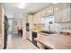 Traditional kitchen with black appliances, tile floors and counters, and light wood cabinets at 8337 Fussell Rd, Polk City, FL 33868