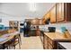 Kitchen with wooden cabinets, black appliances, tiled flooring and a dining area at 8337 Fussell Rd, Polk City, FL 33868