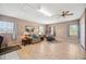 Neutral tone living room with tile floors, windows, and cozy furnishings at 8337 Fussell Rd, Polk City, FL 33868