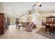 Inviting living room with vaulted ceilings, brick fireplace, and French doors at 8337 Fussell Rd, Polk City, FL 33868