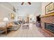 Cozy living room featuring vaulted ceiling, brick fireplace, and neutral decor at 8337 Fussell Rd, Polk City, FL 33868