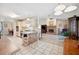 Open floor plan showcasing the kitchen and living room with brick fireplace at 8337 Fussell Rd, Polk City, FL 33868