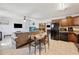 Open-concept living room and kitchen area featuring a ceiling fan, large TV, and aquarium at 8337 Fussell Rd, Polk City, FL 33868