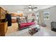 Open-concept living room and kitchen, featuring a comfortable sofa and bright windows at 8337 Fussell Rd, Polk City, FL 33868