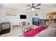 Spacious living room with a large aquarium, sofa, ceiling fan, and tiled floors at 8337 Fussell Rd, Polk City, FL 33868
