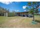 Covered storage area with multiple vehicles and a shipping container for extra storage at 8337 Fussell Rd, Polk City, FL 33868