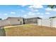 The backyard features a screened-in pool, white fence and walkway to the home's side entrance at 8341 Mitchall Dr, Lakeland, FL 33809