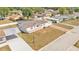 A well-maintained home boasts a covered porch, manicured lawn, and a long driveway at 8341 Mitchall Dr, Lakeland, FL 33809