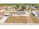 A view shows a well-maintained home with a long driveway and a white fence at 8341 Mitchall Dr, Lakeland, FL 33809