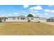 Inviting home with a white porch and green shutters, enhanced by lush landscaping at 8341 Mitchall Dr, Lakeland, FL 33809