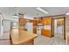 Bright kitchen includes wood cabinets, white appliances, and peninsula with laminate countertop at 8341 Mitchall Dr, Lakeland, FL 33809