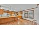 Charming kitchen adjacent to a living area, featuring classic cabinetry and natural light at 8341 Mitchall Dr, Lakeland, FL 33809