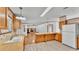 Open kitchen with wood cabinetry, laminate countertops, and view of adjacent living space at 8341 Mitchall Dr, Lakeland, FL 33809