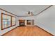 Spacious living room with wood floors, a ceiling fan, and a classic fireplace feature at 8341 Mitchall Dr, Lakeland, FL 33809