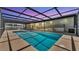 Covered, screened-in pool with a playful rubber ducky and ramp access for all to enjoy at 8341 Mitchall Dr, Lakeland, FL 33809