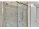 Modern shower features glass door, updated fixtures, and tiled walls at 8341 Mitchall Dr, Lakeland, FL 33809