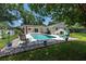 Beautiful backyard with a private pool, lush lawn, and mature trees at 1503 Clairdale Ln, Lakeland, FL 33801