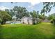 Spacious backyard with a well-maintained lawn and mature trees at 1503 Clairdale Ln, Lakeland, FL 33801