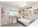 Bright bedroom featuring decor shelving, light wood flooring, and natural light from the window at 1503 Clairdale Ln, Lakeland, FL 33801