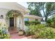 Close-up of front porch, flower arch, brick, potted plants at 1503 Clairdale Ln, Lakeland, FL 33801