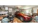 Cluttered garage space with parked car, overhead lighting, and abundant storage at 1503 Clairdale Ln, Lakeland, FL 33801