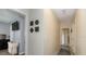 Hallway with decorative wall art and views into adjacent rooms of the home at 1503 Clairdale Ln, Lakeland, FL 33801