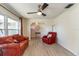 Cozy living room with light wood floors, ceiling fan, and comfortable seating at 1503 Clairdale Ln, Lakeland, FL 33801