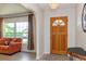 Living room features light wood floor, arched entry and large windows at 1503 Clairdale Ln, Lakeland, FL 33801