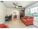 Bright living room featuring hardwood floors, ceiling fan, and large windows at 1503 Clairdale Ln, Lakeland, FL 33801