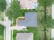 Aerial view of home with gray roof, manicured lawn, and landscaping at 3300 Hawks Ridge Dr, Lakeland, FL 33810