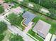 Aerial view of a home with lush landscaping, a long driveway and a dark grey roof at 3300 Hawks Ridge Dr, Lakeland, FL 33810