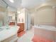 Bright bathroom featuring a large soaking tub and separate vanity area, offering a spa-like experience at 3300 Hawks Ridge Dr, Lakeland, FL 33810
