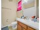 Functional bathroom featuring a single vanity, toilet, and shower with a curtain at 3300 Hawks Ridge Dr, Lakeland, FL 33810