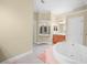 Bright bathroom featuring a garden tub, vanity area, and neutral tones at 3300 Hawks Ridge Dr, Lakeland, FL 33810