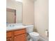 Clean bathroom featuring a white toilet, vanity, and a framed mirror at 3300 Hawks Ridge Dr, Lakeland, FL 33810