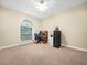 Neutral bedroom with wall to wall carpet, ceiling fan and desk area by the window at 3300 Hawks Ridge Dr, Lakeland, FL 33810