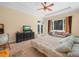 Inviting bedroom featuring a ceiling fan, large window and a couch for added seating space at 3300 Hawks Ridge Dr, Lakeland, FL 33810