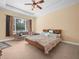 Spacious bedroom featuring a ceiling fan, large window and a couch for added seating space at 3300 Hawks Ridge Dr, Lakeland, FL 33810