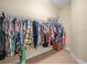 Walk-in closet with ample hanging storage on the metal rack and neutral carpet at 3300 Hawks Ridge Dr, Lakeland, FL 33810