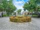 Community entrance featuring stone pillars, an iron gate, and lush landscaping, offering security and elegance at 3300 Hawks Ridge Dr, Lakeland, FL 33810