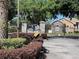 Upscale gated community entrance with stone accents and well-maintained landscaping at 3300 Hawks Ridge Dr, Lakeland, FL 33810