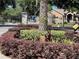 Elegant community entrance showcasing stone pillars, a palm tree, and a gated entry at 3300 Hawks Ridge Dr, Lakeland, FL 33810