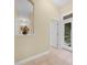 Bright hallway with a decorative mirror, tile floors, and access to the backyard at 3300 Hawks Ridge Dr, Lakeland, FL 33810