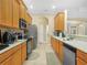 Bright kitchen with stainless steel appliances, tile flooring, and plentiful cabinet space at 3300 Hawks Ridge Dr, Lakeland, FL 33810