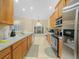 Spacious kitchen featuring tile floors, wood cabinets, and stainless steel appliances at 3300 Hawks Ridge Dr, Lakeland, FL 33810