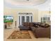 Inviting living room with a comfortable leather sectional and a view of the property on television at 3300 Hawks Ridge Dr, Lakeland, FL 33810