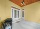 Covered patio with ceiling fan, grill, and access to the interior at 3300 Hawks Ridge Dr, Lakeland, FL 33810