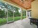 Screened-in lanai for outdoor dining and relaxation with a view of the well-kept backyard at 3300 Hawks Ridge Dr, Lakeland, FL 33810